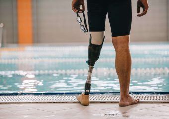 A photo of a swimmer with a prosthetic leg.