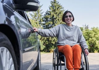 Wheelchair user with her vehicle