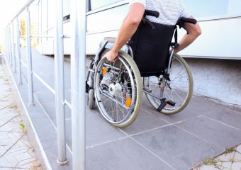 Header photo of a wheelchair user on a modular ramp