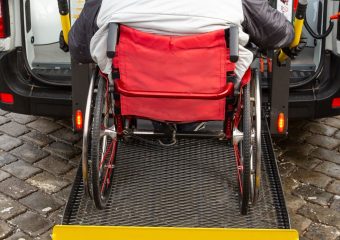 Wheelchair accessible vehicle user on a ramp. Header image.